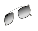 A pair of Randolph x BKC P-51 sunglasses clip-on in gunmetal color, featuring modern, square-shaped dark lenses with a thin metal frame.