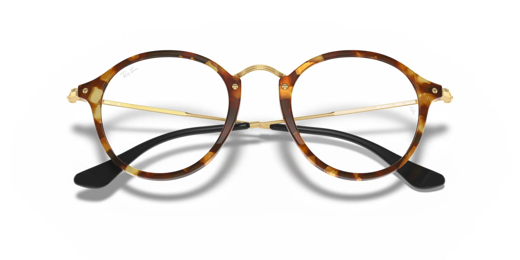 Round tortoiseshell Ray-Ban ROUND RX2447V eyeglasses feature a thin gold bridge and temples with black earpieces, offering a classic and timeless look in size 49.