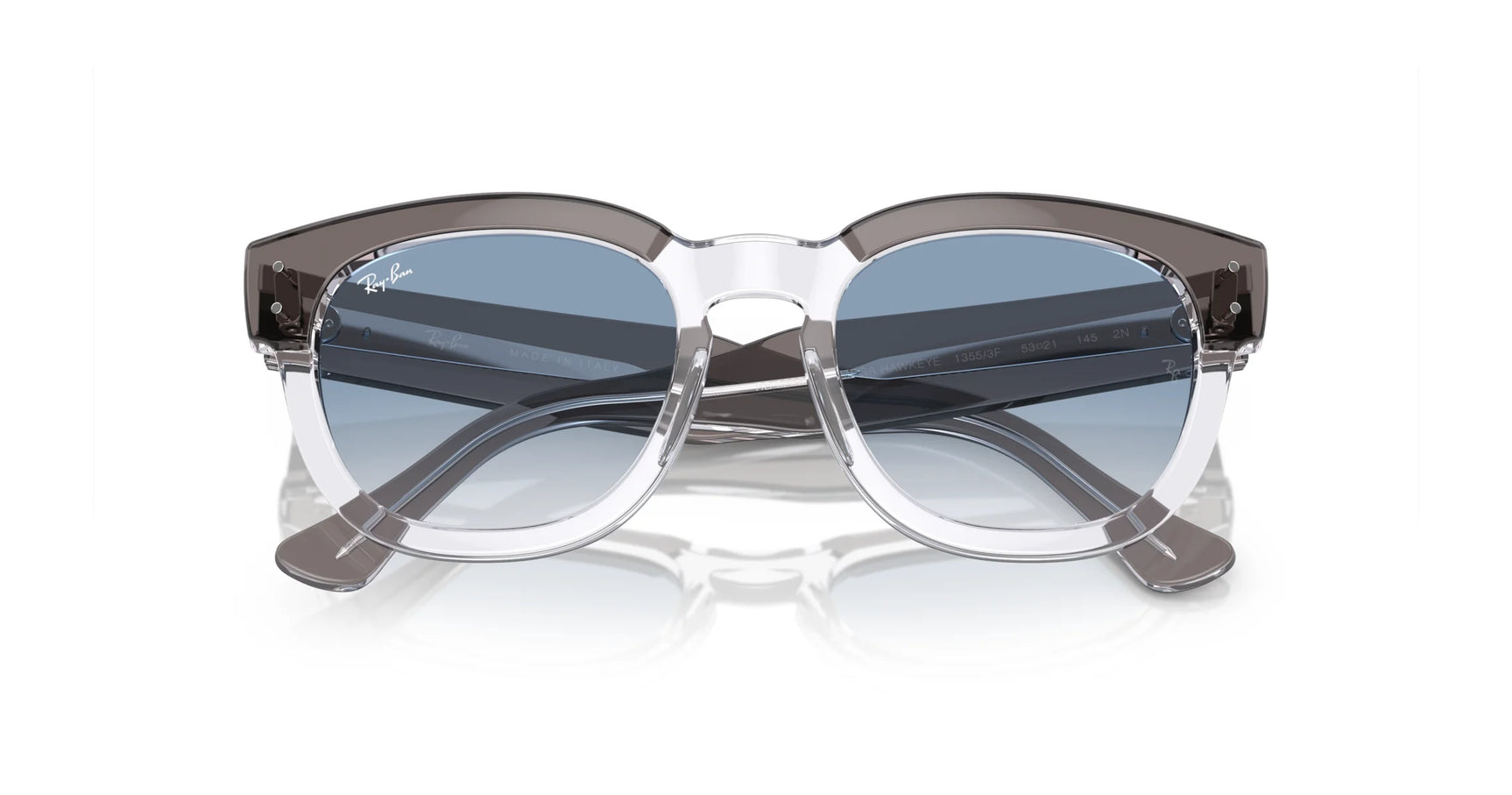 The Ray-Ban MEGA HAWKEYE RB0298SF sunglasses, size 53, feature a square shape with clear and gray frames and blue-tinted lenses, elegantly displayed on a white background.