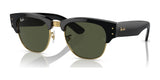 Ray-Ban MEGA CLUBMASTER RB0316S sunglasses, featuring black on gold frames and green lenses, rest elegantly on a reflective surface, blending classic design with contemporary eyewear style.