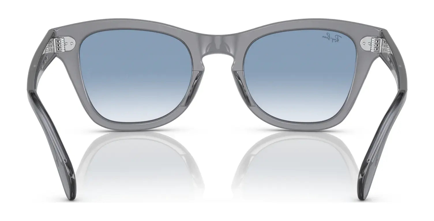 The Ray-Ban RB0707S sunglasses feature a sleek acetate frame with blue gradient, polarized lenses, dazzling on a white surface.