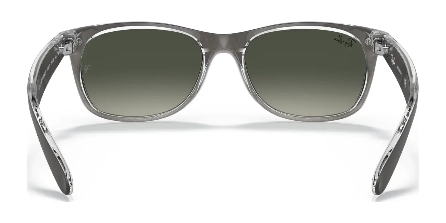 The Ray-Ban NEW WAYFARER RB2132 Sunglasses in size 52 feature clear frames and dark gradient lenses, providing chic style and superb sun protection when viewed from the front.