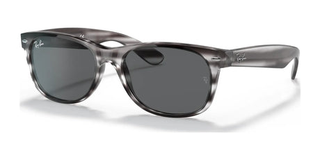 Explore the Ray-Ban NEW WAYFARER RB2132 Sunglasses in size 52. They feature dark lenses, a gray translucent frame, and a subtle temple logo, combining style with superior sun protection for all your adventures.