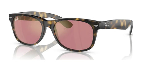 These Ray-Ban NEW WAYFARER RB2132 sunglasses have tortoiseshell frames and pink lenses with a classic design, offering stylish UV protection.