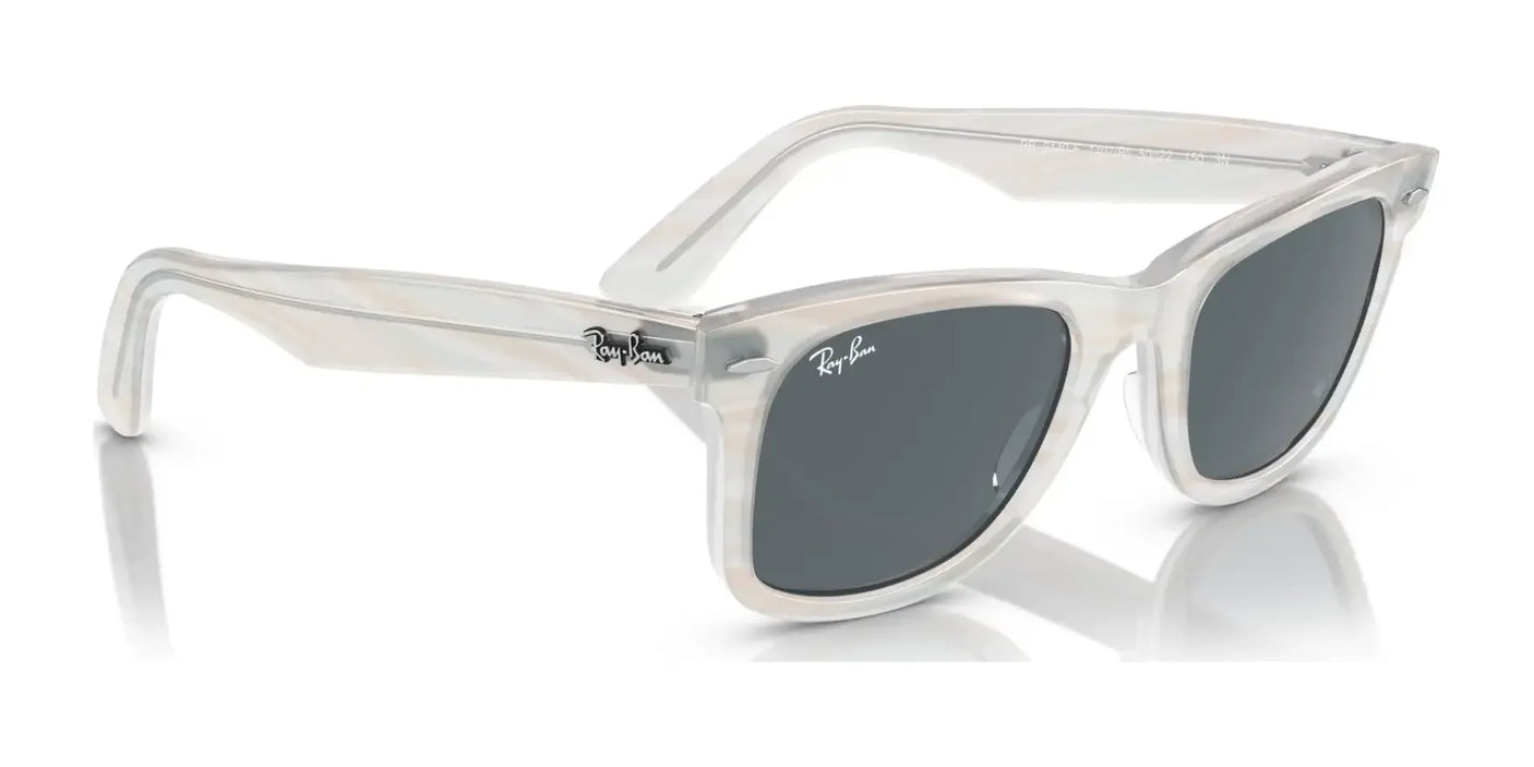 Angled view of the Ray-Ban WAYFARER RB2140F sunglasses with clear frames, dark lenses, and UV protection.