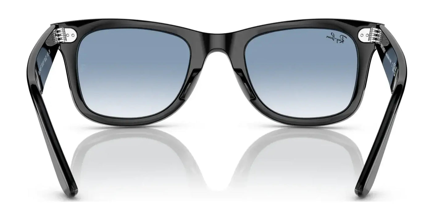 These chic Ray-Ban WAYFARER RB2140F sunglasses feature a sleek black frame with gradient blue lenses, elegantly showcased on a reflective surface. Crafted from durable acetate, they provide stylish UV protection for your eyes.