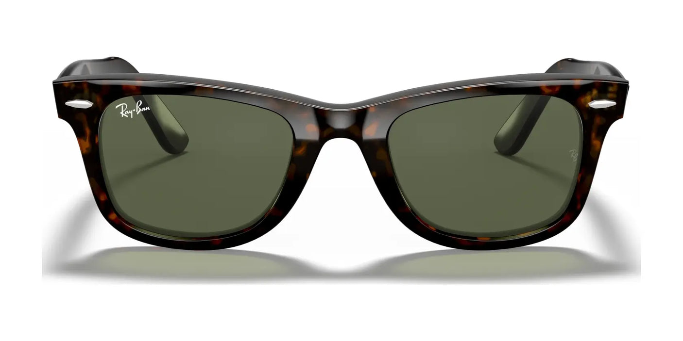 The Ray-Ban WAYFARER RB2140F sunglasses, with their tortoiseshell frame and dark green lenses, provide stylish UV protection and maintain a timeless appearance when seen from the front.