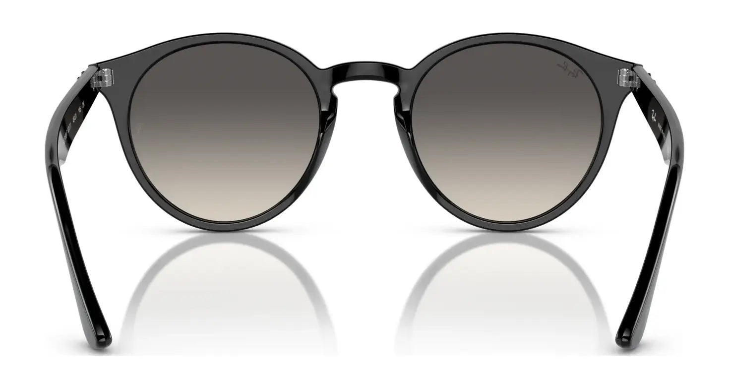 Ray-Ban RB2180F Sunglasses in black, featuring round frames with gradient lenses and UV protection, beautifully reflect on a white surface.