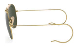 The Ray-Ban OUTDOORSMAN I RB3030 Sunglasses, featuring thin gold wire frames and round dark polarized lenses, viewed from the side on a white background, exude classic Ray-Ban style.