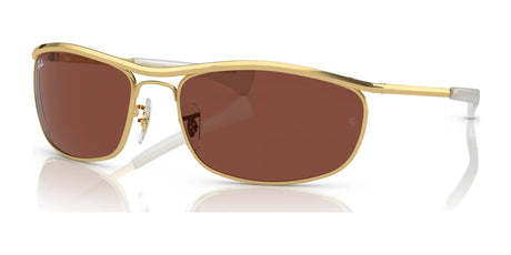 Ray-Ban OLYMPIAN I DELUXE RB3119M Sunglasses with metallic frames and brown lenses, size 62, rest stylishly on a reflective surface, offering UV protection.