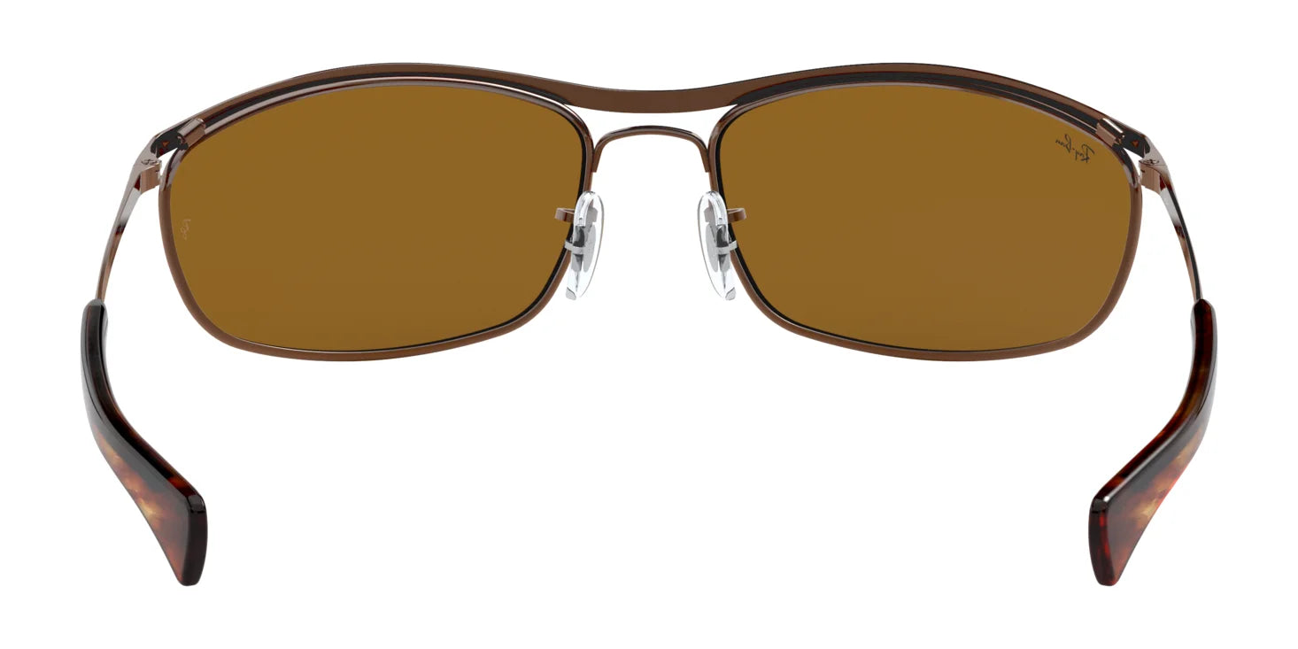 The Ray-Ban OLYMPIAN I DELUXE RB3119M Sunglasses, size 62, feature rectangular lenses with a sleek metallic frame and adjustable nose pads for stylish UV eye protection.