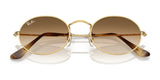 The Ray-Ban OVAL RB3547 Sunglasses feature premium materials with gold oval frames and brown gradient lenses, viewed from the front.