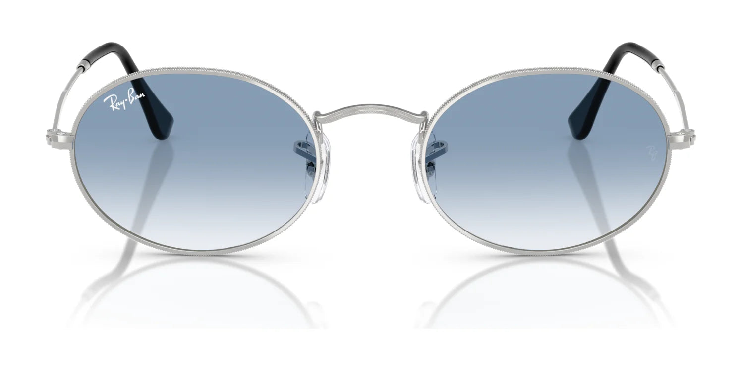 Ray-Ban OVAL RB3547 sunglasses, featuring silver frames and blue-tinted lenses, crafted from premium materials, are showcased on a white background.