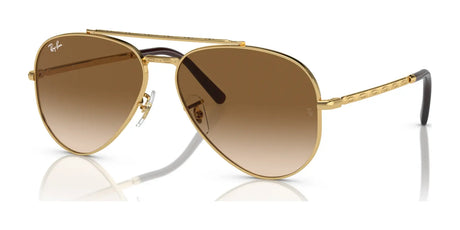 The Ray-Ban NEW AVIATOR RB3625 gold sunglasses feature UV-protective brown gradient lenses and engraved arms, shown on a white background.