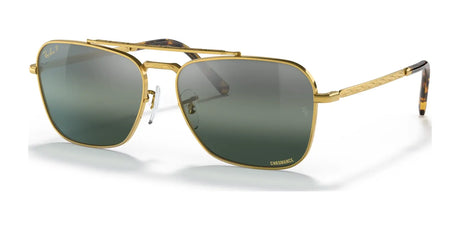 The Ray-Ban NEW CARAVAN RB3636 sunglasses with gold frames and dark lenses, featuring premium engravings, are elegantly displayed on a white background.