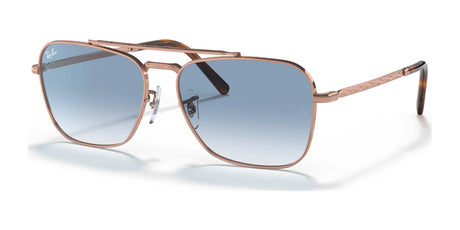 The Ray-Ban NEW CARAVAN RB3636 sunglasses have a gold frame, blue gradient lenses, and premium engravings.