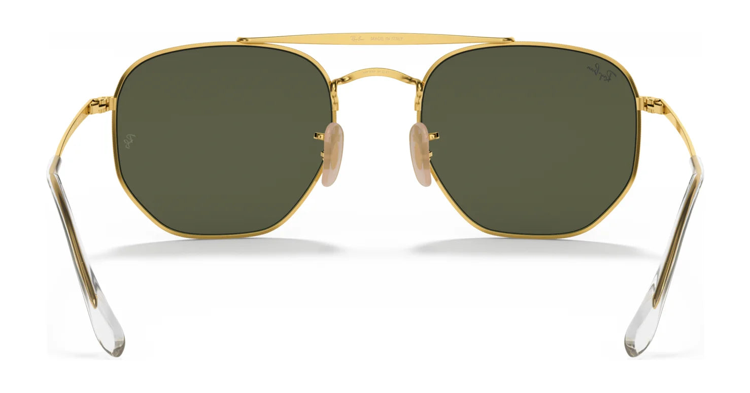 Hexagonal gold-framed Ray-Ban THE MARSHAL RB3648 sunglasses in size 54, featuring high-quality dark green lenses, clear earpieces, and adjustable nose pads.