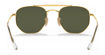 Hexagonal gold-framed Ray-Ban THE MARSHAL RB3648 sunglasses in size 54, featuring high-quality dark green lenses, clear earpieces, and adjustable nose pads.