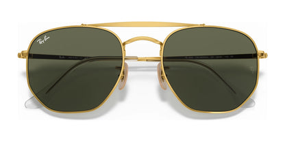 The Ray-Ban THE MARSHAL RB3648 Sunglasses in Size 54 feature gold-framed aviator design with dark green, high-quality lenses and a brand logo in the upper left corner of the left lens. As the perfect outdoor accessory for those who appreciate style and sophistication, these sunglasses effortlessly blend fashion with function.