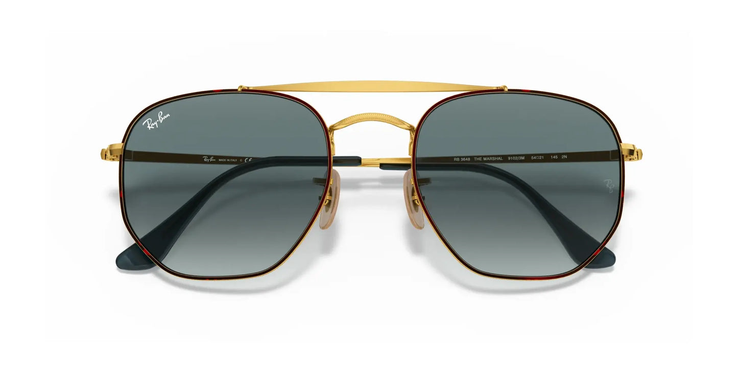 The Ray-Ban THE MARSHAL RB3648 Sunglasses, sized at 54, feature a gold frame with high-quality green lenses and a double bridge, proudly displaying the iconic Ray-Ban logo on the lenses.