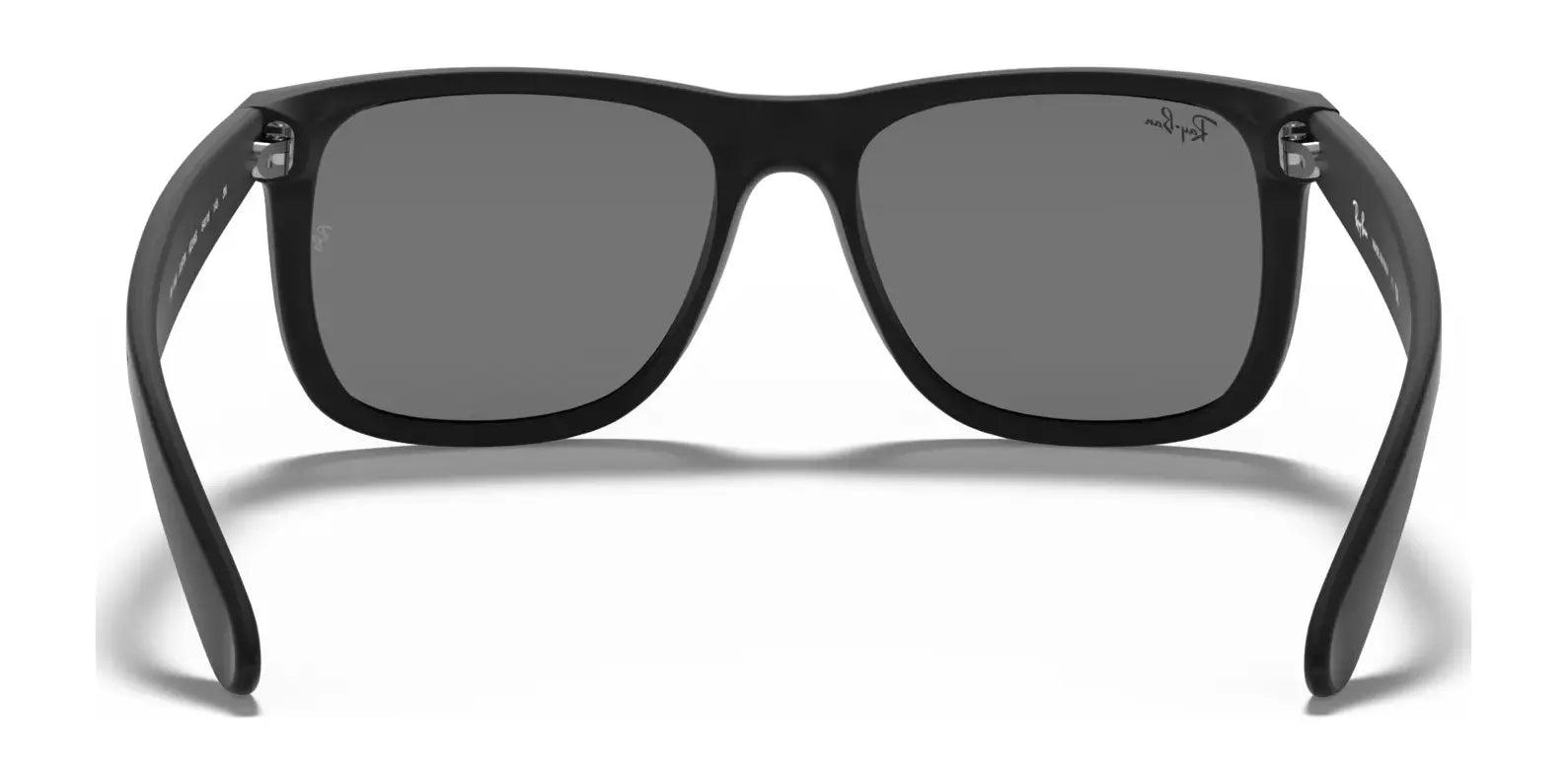 Experience timeless style with Ray-Ban JUSTIN RB4165 sunglasses, featuring sleek black frames and dark lenses. Designed for flair and function, they offer 100% UV protection, ensuring your eyes stay safe while you look effortlessly cool against a pristine white backdrop.