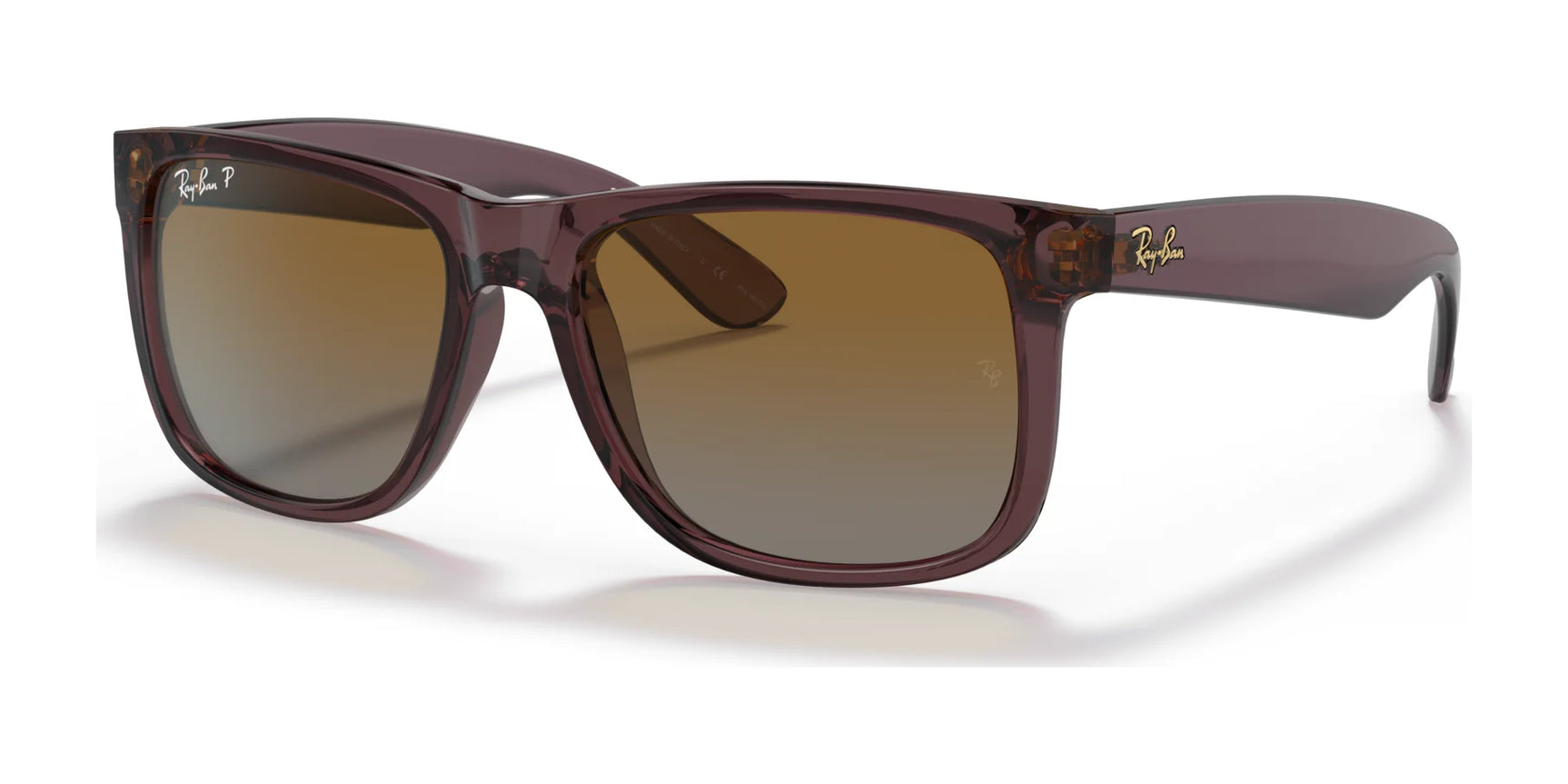 A pair of Ray-Ban JUSTIN RB4165 sunglasses in transparent dark brown №6597T5 with dark lenses and 100% UV protection, set against a white background.