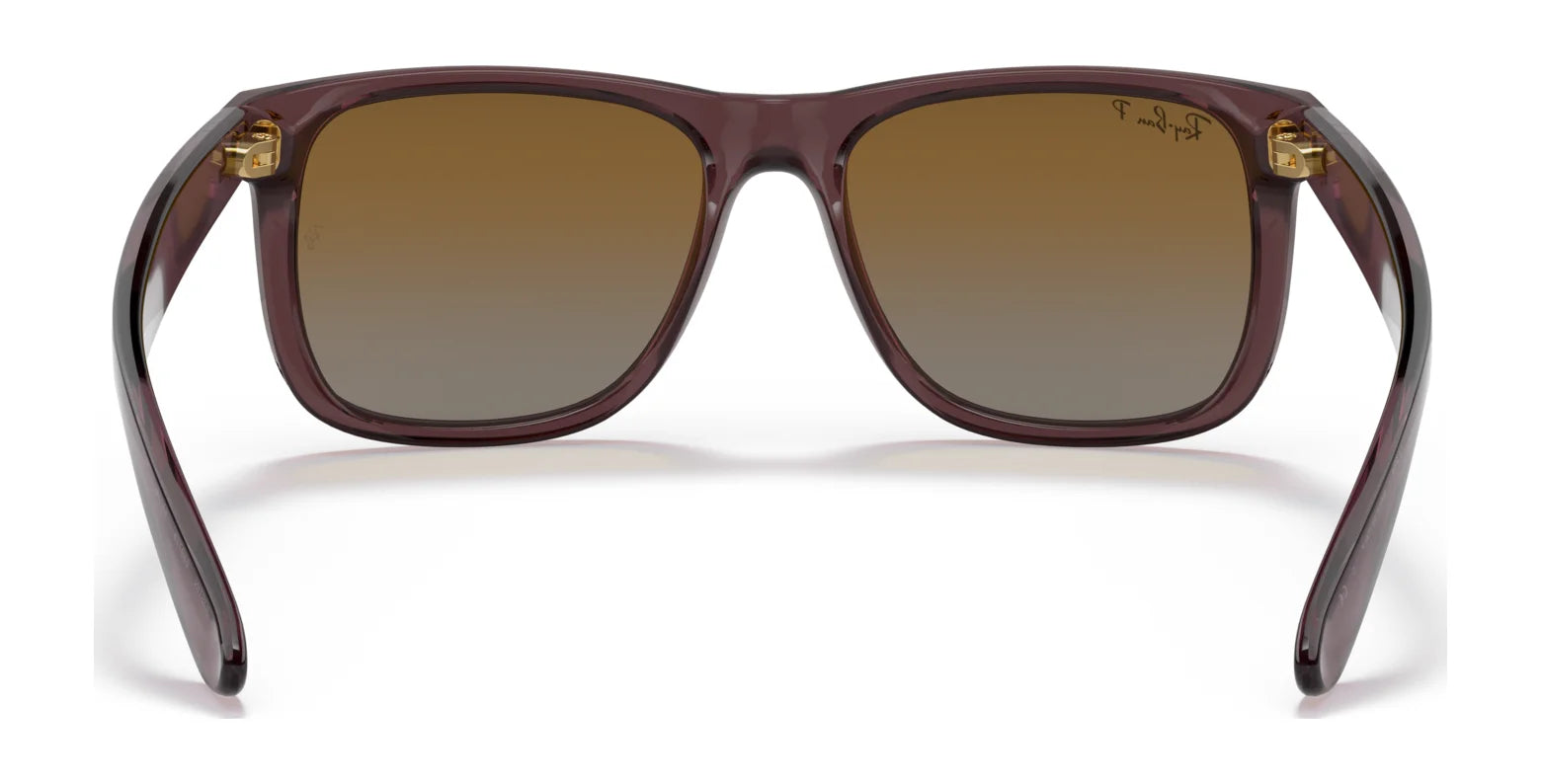 The Ray-Ban JUSTIN RB4165 sunglasses have a square shape with brown gradient lenses, 100% UV protection, and a subtle Ray-Ban logo on the top corner of the right lens.