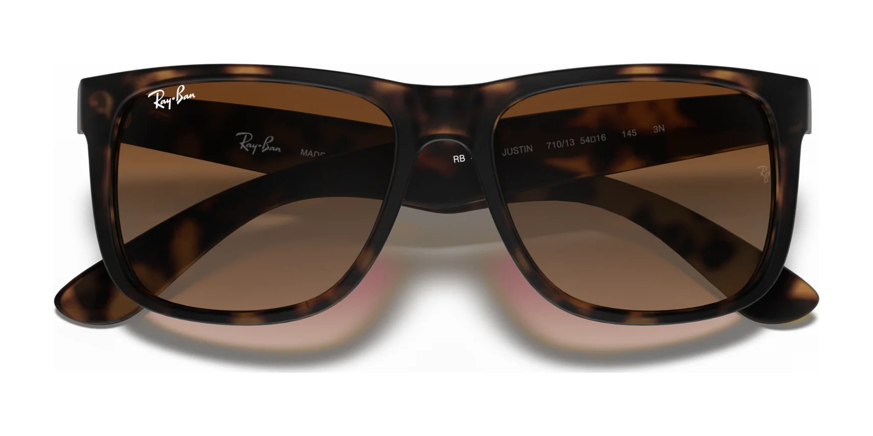 The Ray-Ban JUSTIN RB4165 sunglasses feature a tortoiseshell square frame with brown lenses offering 100% UV protection, elegantly displayed against a white background.