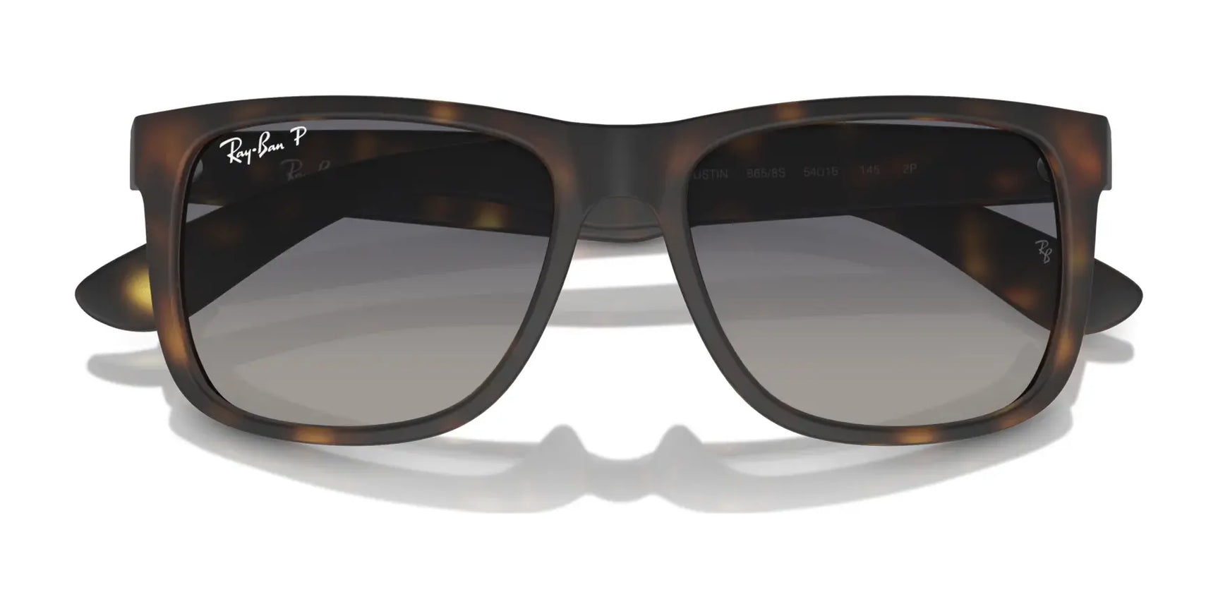 Close-up of Ray-Ban JUSTIN RB4165 sunglasses in tortoiseshell with gray gradient lenses, offering 100% UV protection, set against a white background.