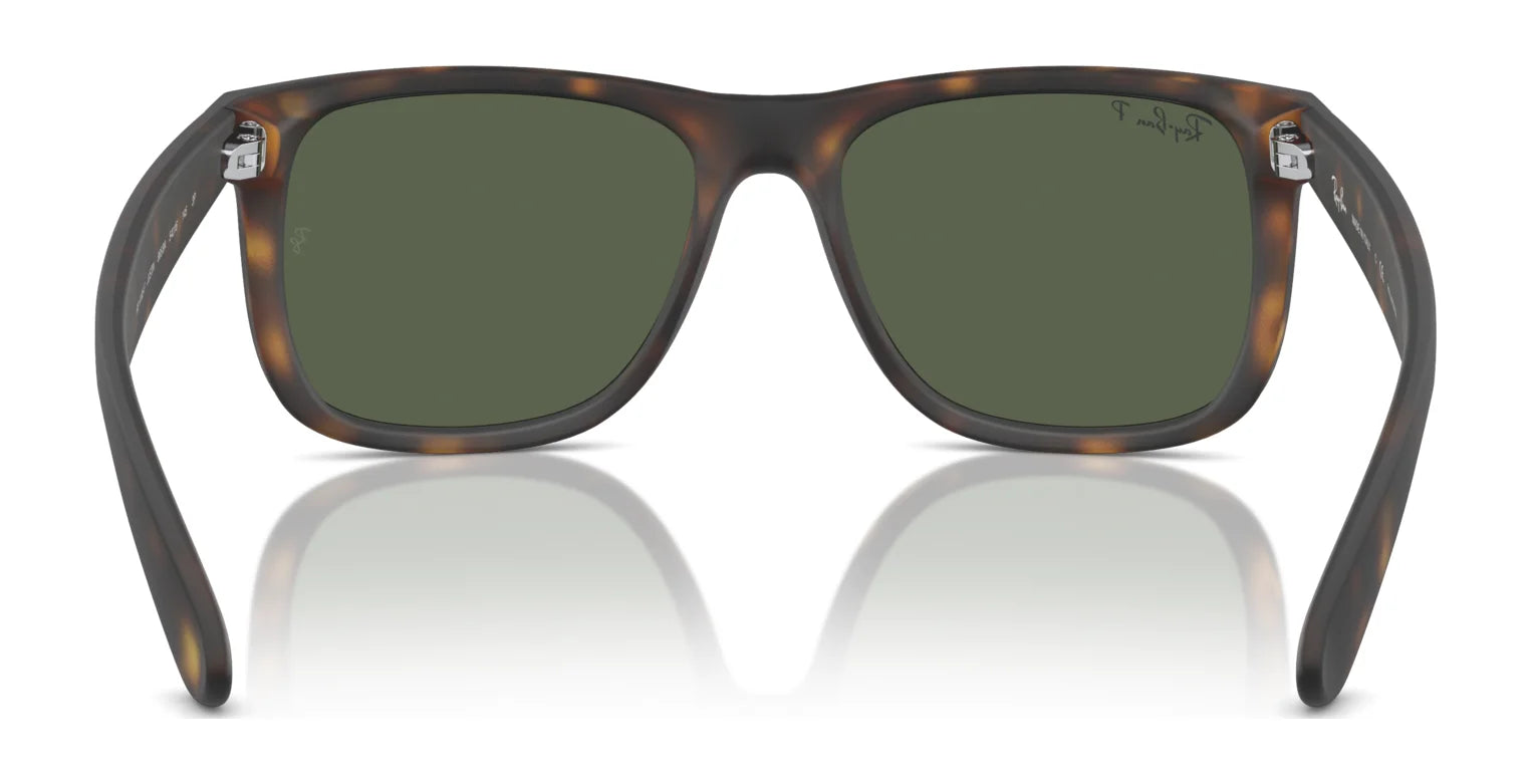 Ray-Ban JUSTIN RB4165F sunglasses feature tortoise shell square frames and green UV-protective lenses, displayed frontally on a reflective white surface.