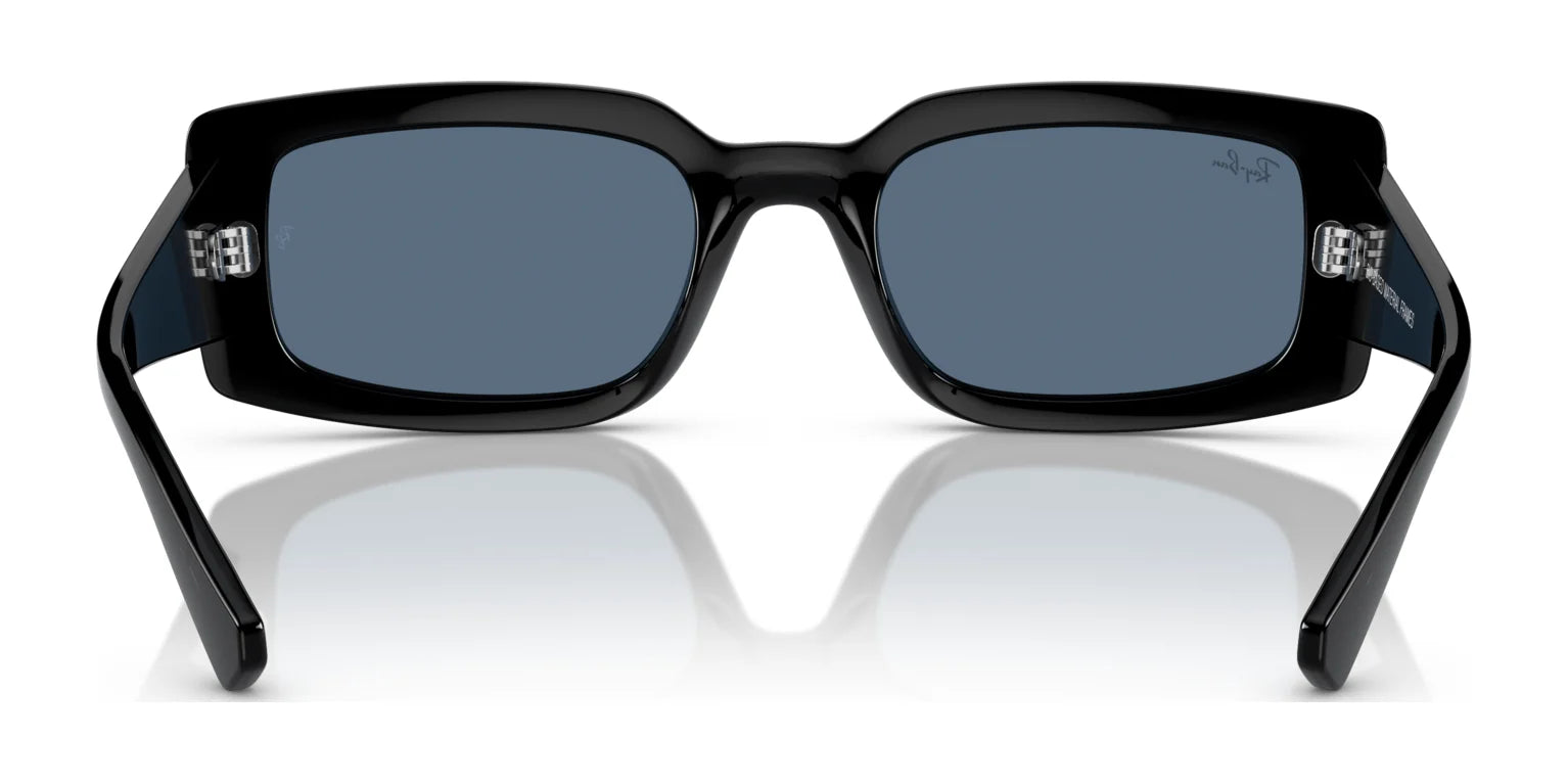 The Ray-Ban KILIANE RB4395 Sunglasses, size 54, showcase a sleek rectangular black frame made from bio-based acetate and dark UV-protection lenses, elegantly displayed on a reflective surface.