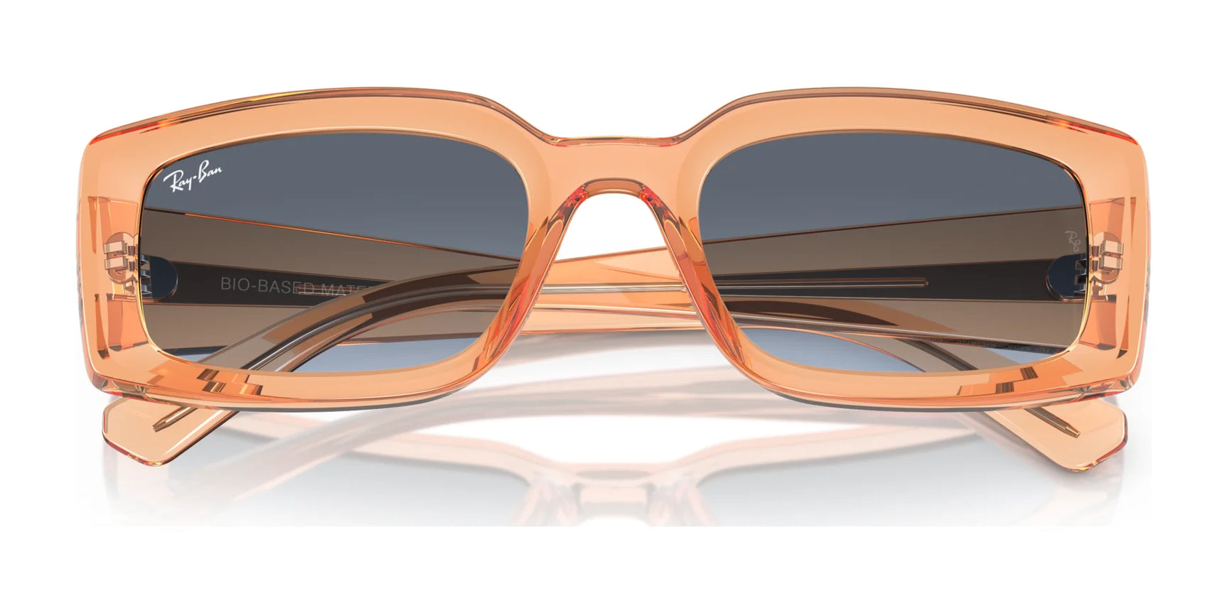 The Ray-Ban KILIANE RB4395 Sunglasses, size 54, feature orange rectangular frames crafted from bio-based acetate with dark lenses that offer UV protection, reflecting light on a white surface.