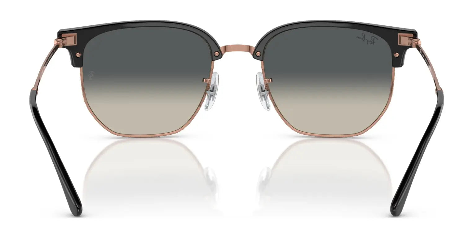 Ray-Ban NEW CLUBMASTER RB4416F Sunglasses feature a black and gold frame with a hexagonal design and gradient tint polarized lenses, as seen from the front.