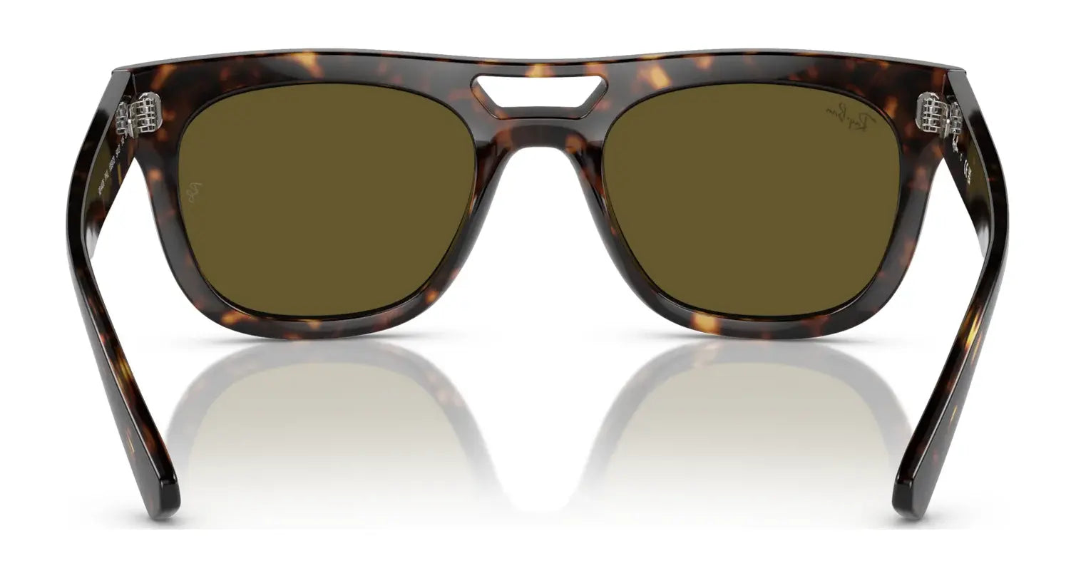 The Ray-Ban PHIL RB4426 Sunglasses in size 54 feature a squared silhouette, dark lenses, and a distinctive bridge design.