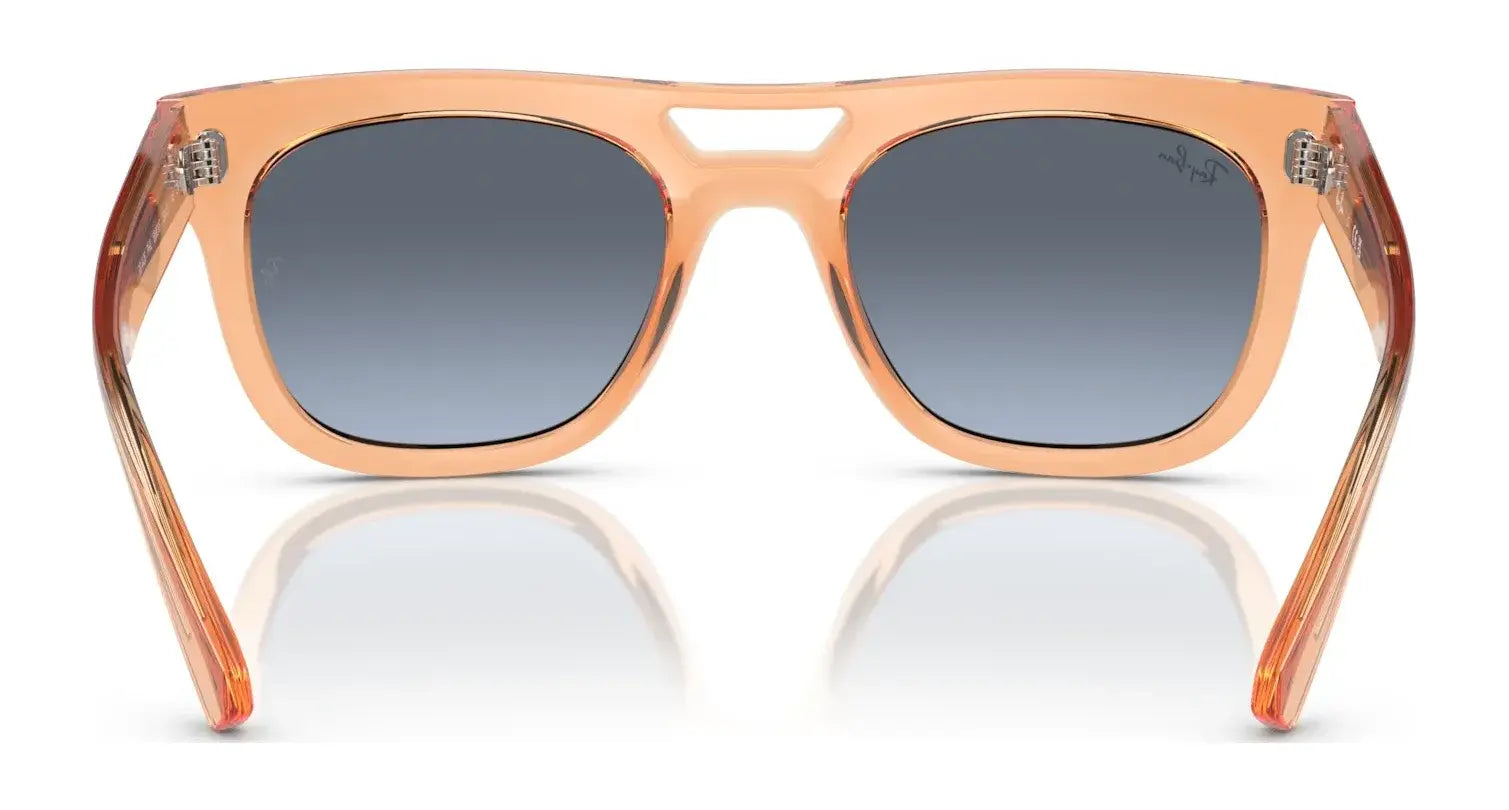 The Ray-Ban PHIL RB4426 Sunglasses offer stylish UV protection with translucent peach frames and dark gradient lenses, in a trendy square shape. Displayed on a crisp white background, they blend fashion with function seamlessly. Size 54.