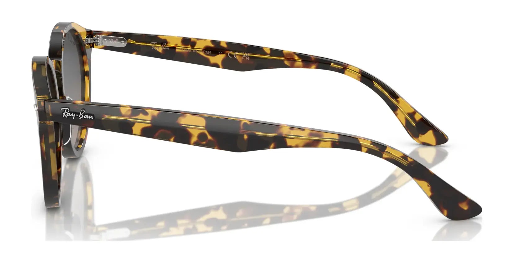 A side view of Ray-Ban LARRY RB7680S tortoiseshell-patterned sunglasses, crafted from premium acetate, elegantly reflecting on a white surface.