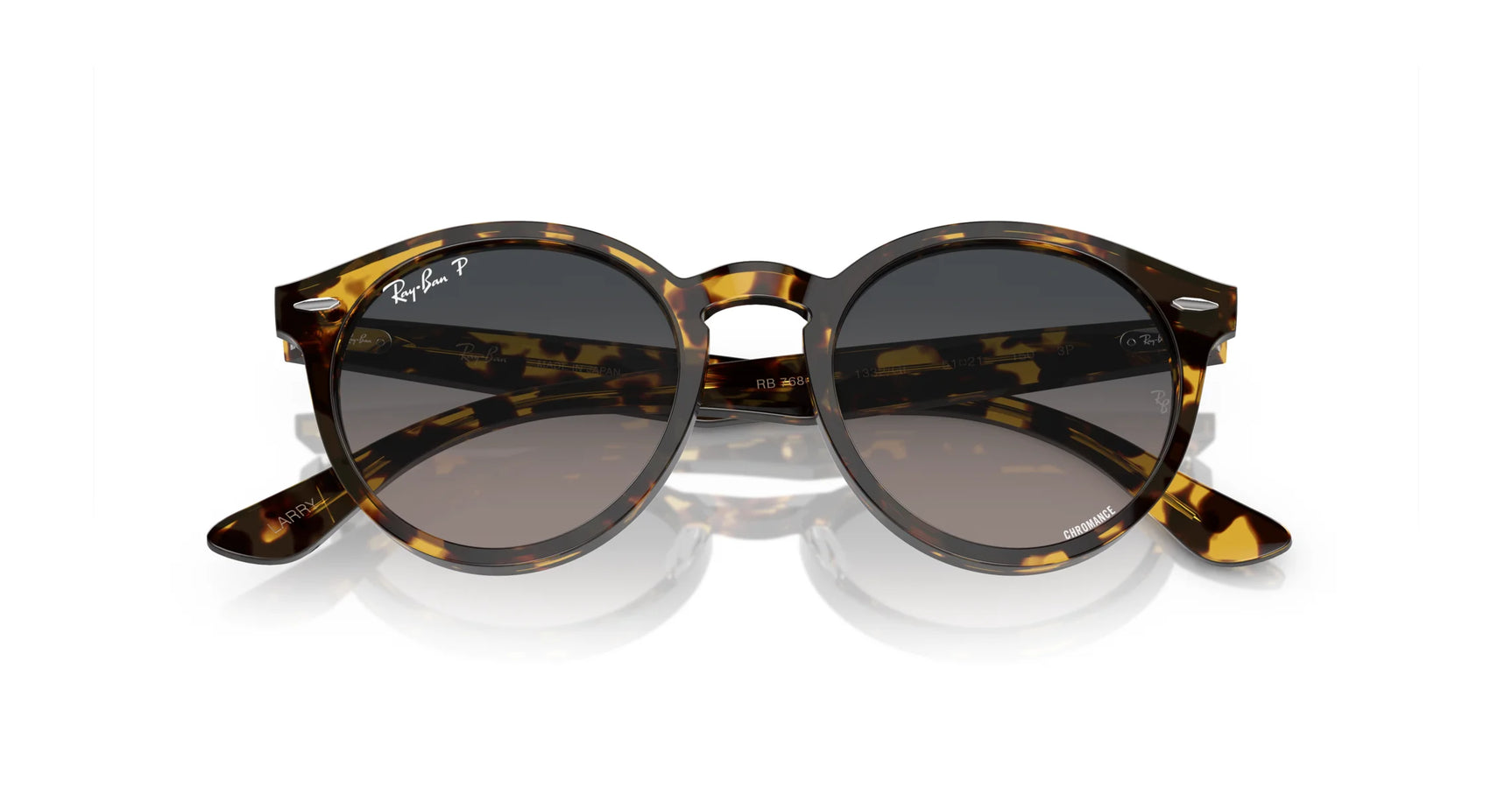 Ray-Ban LARRY RB7680S Sunglasses sit on a white surface, showcasing premium acetate round tortoiseshell frames with dark lenses and Ray-Ban branding for a sleek finish.