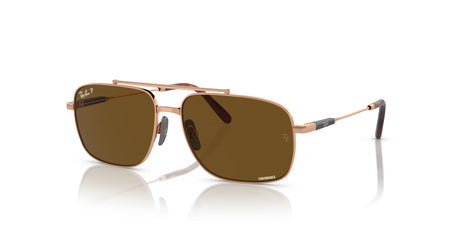 Ray-Ban MICHAEL TITANIUM RB8096 sunglasses, featuring brown-tinted aviator lenses with gold frames and a double bridge for UV protection, displayed on a white reflective surface.