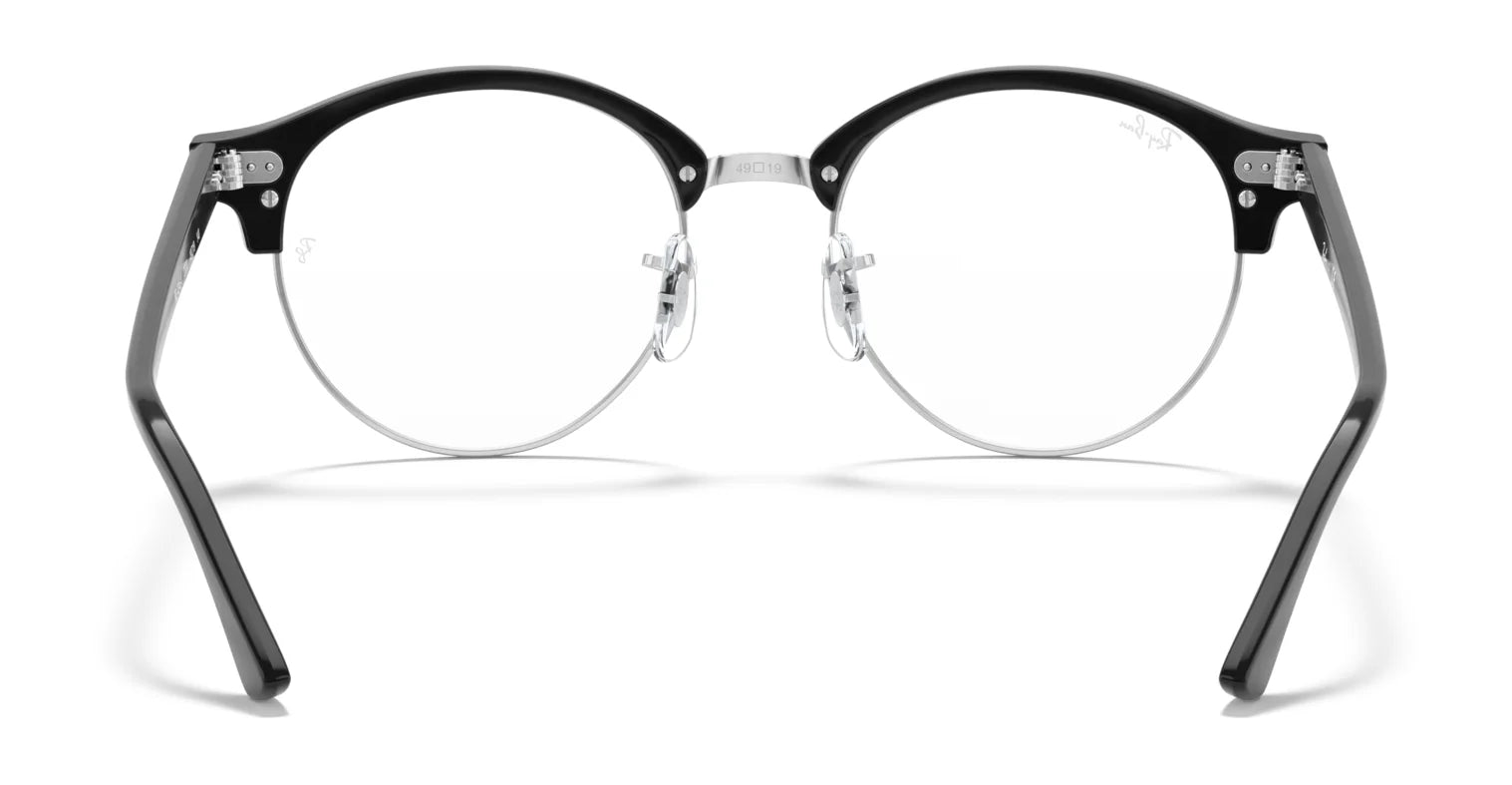 The Ray-Ban CLUBROUND RX4246V Eyeglasses in black and silver, size 49, feature a metal nose bridge and clear lenses that elegantly highlight their timeless round shape.