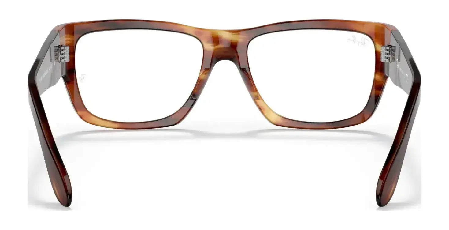 The Ray-Ban NOMAD WAYFARER RX5487 eyeglasses, with their tortoiseshell square acetate frames, boast thick, bold styling reminiscent of the iconic Ray-Ban Wayfarer. Set against a white background, these frames are designed to accommodate prescriptions for ultimate convenience.