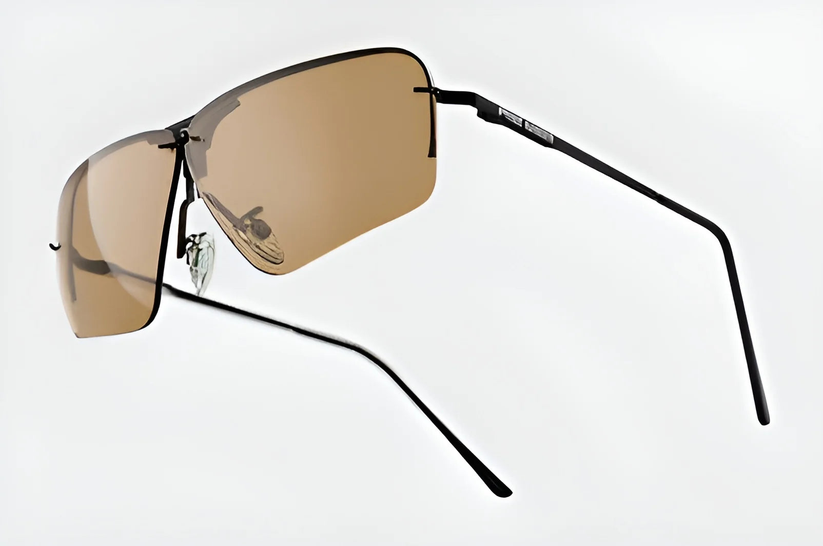 Rimless brown-tinted shooting glasses with RE Ranger Edge frames and sleek black temples on a white background, combining elegance and functionality.