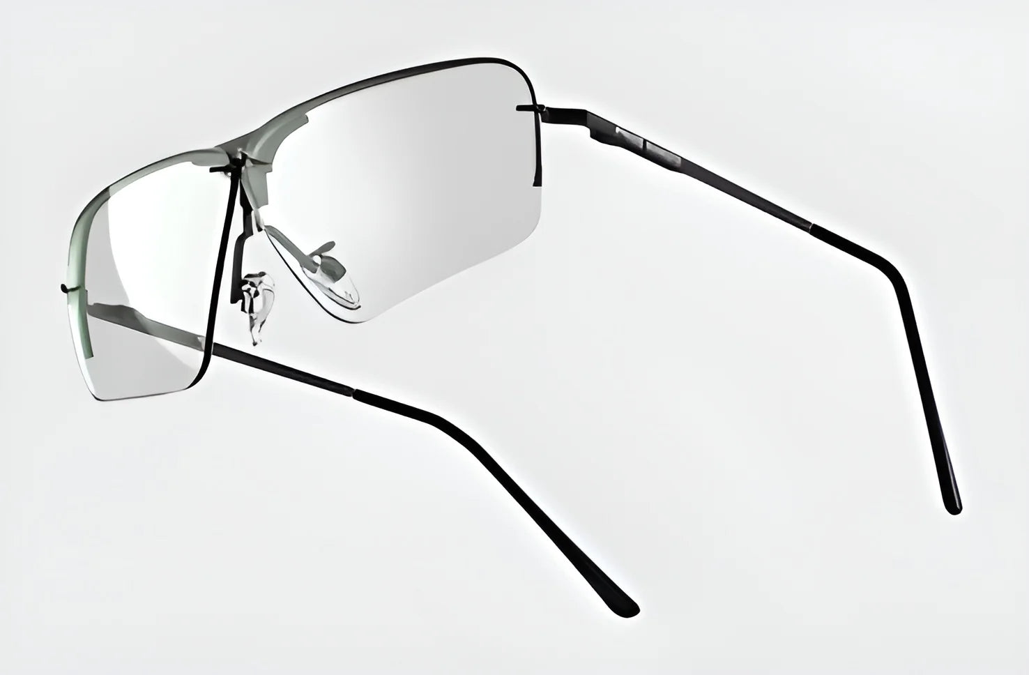 Introducing the RE Ranger Edge Shooting Glasses by RE Ranger, featuring sleek, rimless angular lenses supported by black metal arms and reflective interchangeable NexPC lenses set against a light gray backdrop.