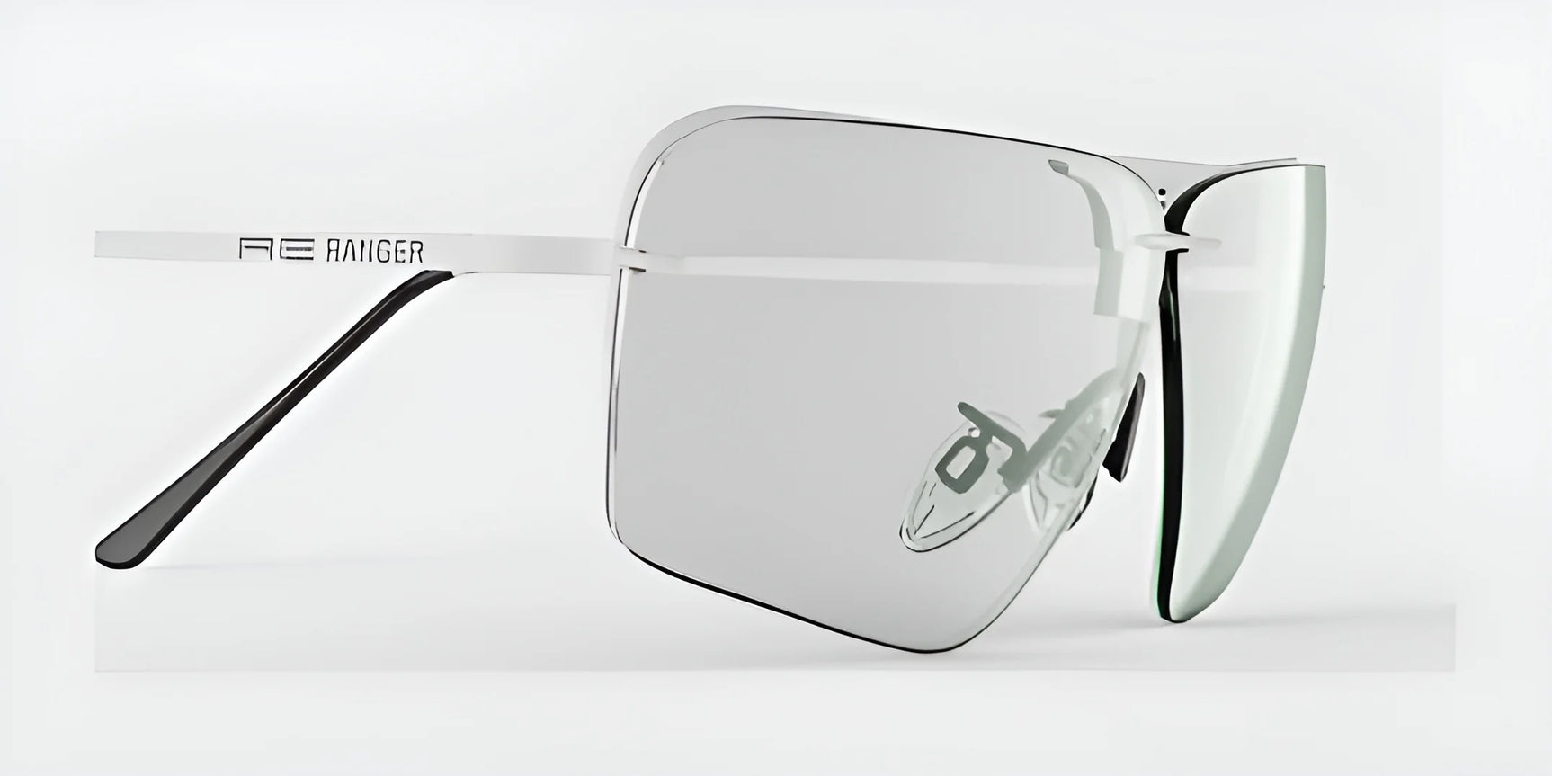 Presenting the RE Ranger Edge Shooting Glasses by RE Ranger, these shooting glasses boast a modern, sleek frameless design and reflective angular lenses set against a white background, guaranteeing enhanced optical performance.