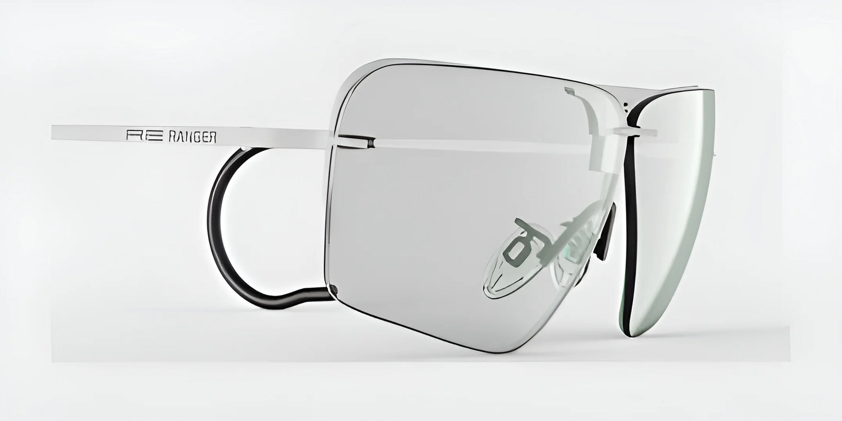 The RE Ranger Edge Shooting Glasses are modern and stylish, featuring large, angular lenses with slim white frames for a personalized fit, complete with prominent RE Ranger branding on the side.