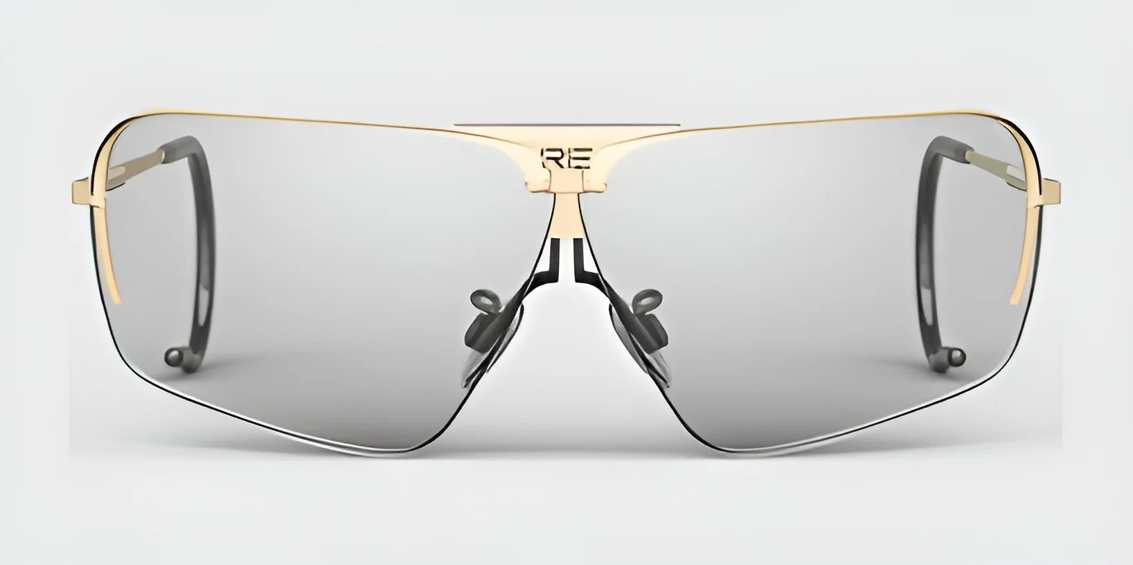 RE Ranger Edge Shooting Glasses by RE Ranger offer a sleek design with a gold frame and angular gray lenses. They come with nose pads for a customized fit and black temple tips.