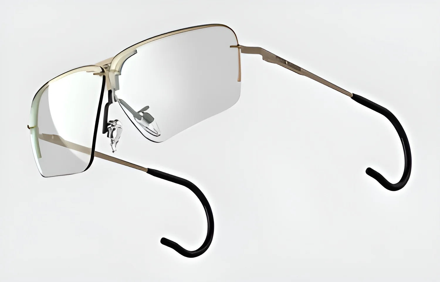 The RE Ranger Edge Shooting Glasses, by RE Ranger, are frameless sunglasses showcasing angular lenses with reflective surfaces and black-tipped metal earpieces set against a white background.