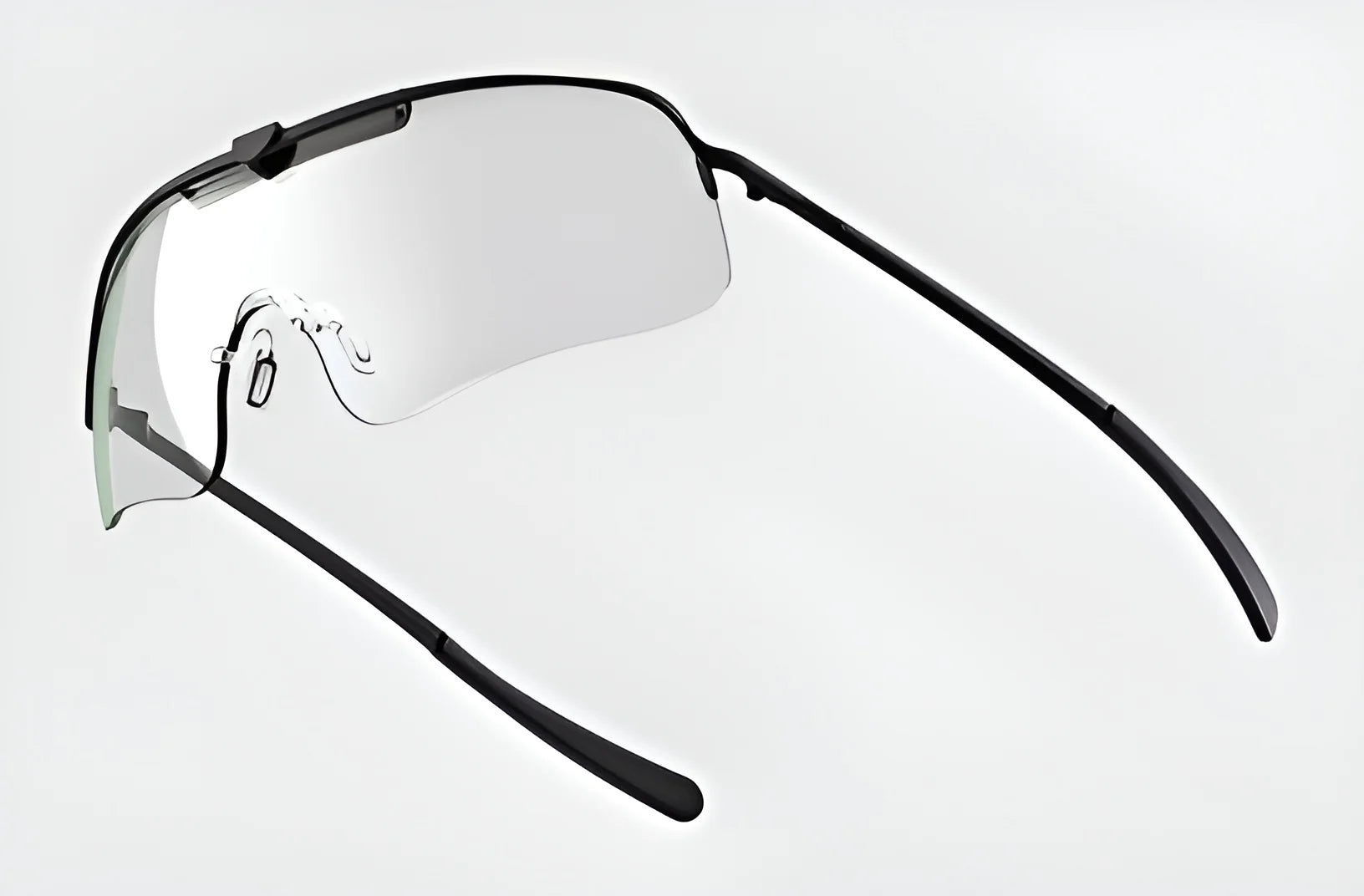 Introducing the RE Ranger Falcon Pro Shooting Glasses by RE Ranger—chic, minimalistic sports eyewear with black rims, featuring an aerodynamic lens design and advanced CombatCoat technology, set against a white backdrop.