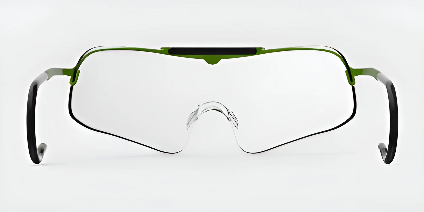 Close-up of RE Ranger Falcon Pro Shooting Glasses, featuring an aerodynamic lens and green accents with a clear CombatCoat, set against a plain background.