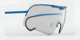 The RE Ranger Falcon Pro Shooting Glasses, by RE Ranger, are highlighted on a white background with their aerodynamic lenses and blue frames, transparent lenses, and minimalist design.