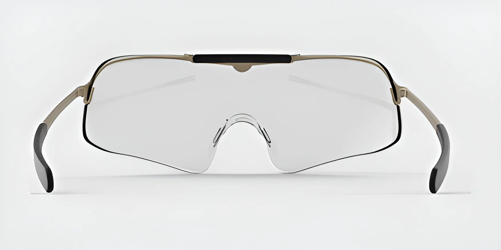 The RE Ranger Falcon Pro Shooting Glasses, featuring a sleek oversized visor-style design with an aerodynamic lens and thin metal frame, are set against a neutral background. The clear lenses offer a modern touch while ensuring versatility for any look—perfect for individuals seeking both style and function.